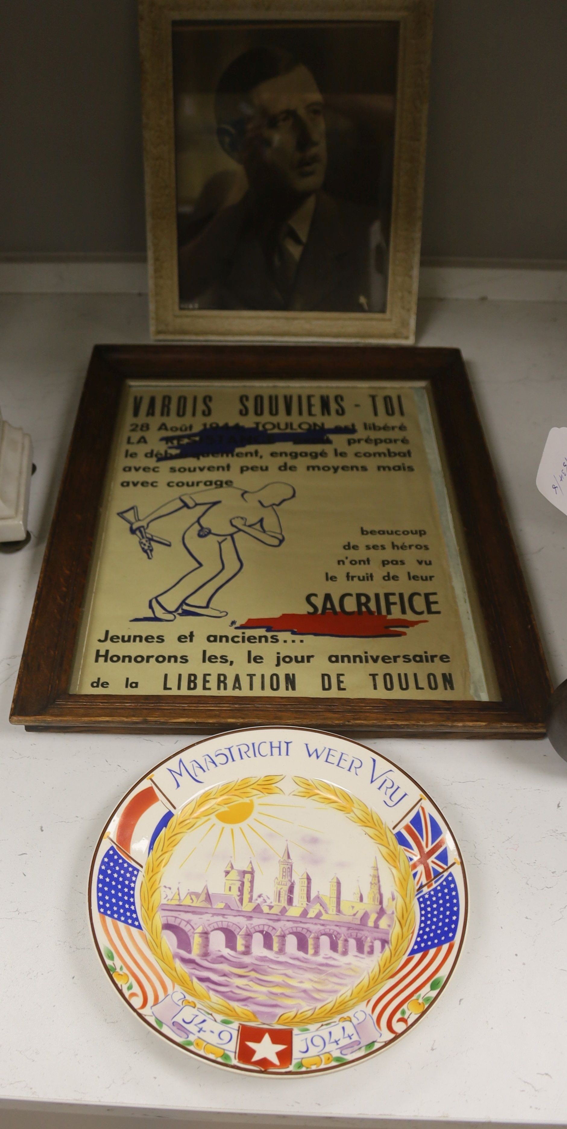 Monochrome photograph bearing signature Gen. De Gaul, dated 1949, together with a Liberation poster, Toulon 1944, a Liberation of Maastricht plate, 1944, and a rare Swiss Red Cross Prisoner's Parcels box